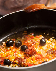 Stir-frying vegetables and sausage