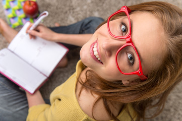 Woman student sitting thinking while studying.