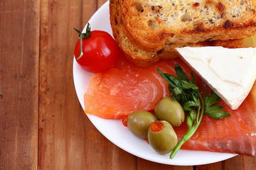 toast salmon and herbs on a wooden background