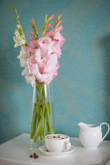 beautiful gladiolus bouquet and coffee cup