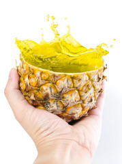 Hand Holding Splash Pineapple Juice