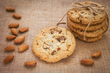 Chocolate chip cookie with almond on wooden background