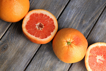 Ripe grapefruits on wooden background