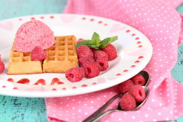 Tasty belgian waffles with ice cream on wooden table