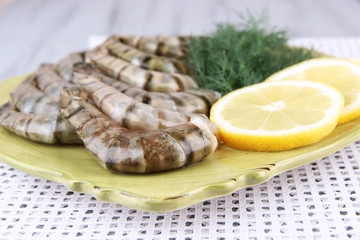 Square plate of prawns with dill and lemon