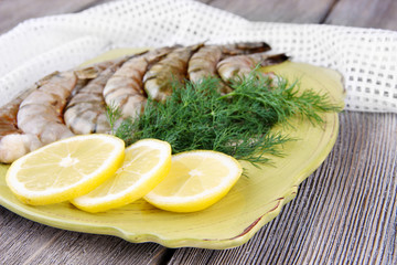 Square plate of prawns with dill and lemon