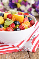 Delicious fruits salad in plate on table close-up
