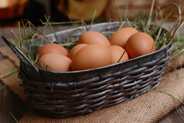 Eggs in wicker basket on table close-up