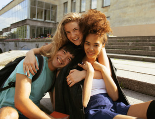 cute group teenages at the building of university with books