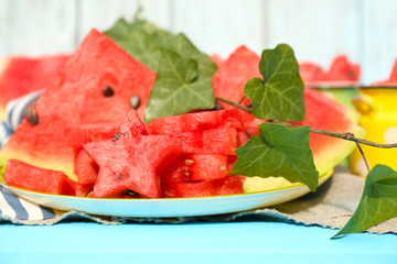 Fresh slices of watermelon on table, on wooden background