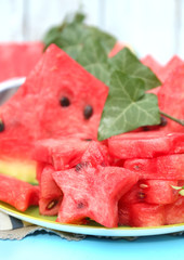 Fresh slices of watermelon on table, on wooden background