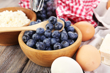 Fresh blueberries and milk products on wooden table