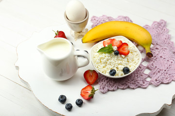 Delicious breakfast with cottage cheese, milk and fruits
