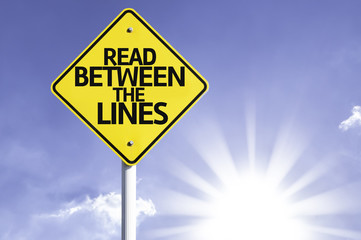 Read Between the Lines road sign with sun background