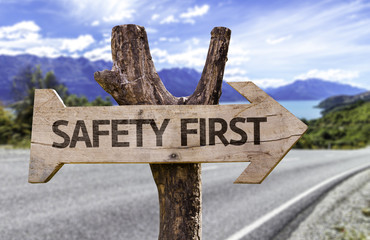 Safety First wooden sign with a street background