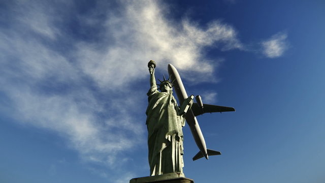 Airplane flying over the Statue of Liberty
