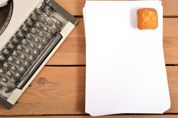 Typewriter, notebook and pencils