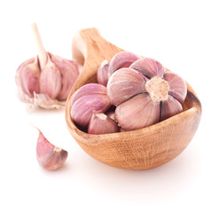 Garlic cloves in wooden bowl isolated on white background