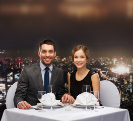 smiling couple holding hands at restaurant