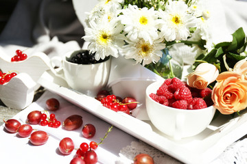 Still life with berries and flowers