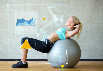 smiling woman with exercise ball in gym