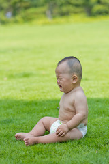 crying baby in the park lawn