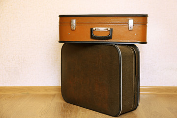 Vintage old travel suitcases on floor