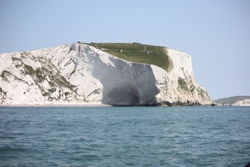 white cliffs towering above a blue sea