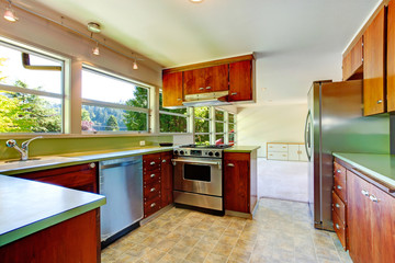 Kitchen room with wooden cabinets and steel stainless appliances