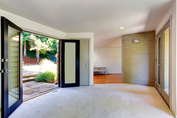 Empty house interior. Living room with door to backyard