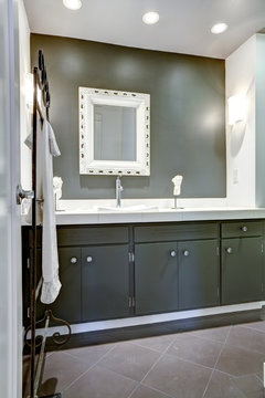 Dark bathroom vanity cabinet with white top