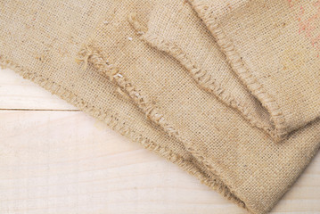 Fototapeta na wymiar Gunny sack texture and wood plank table background