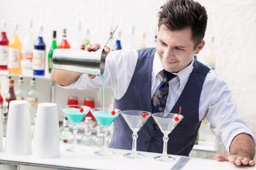 barman pouring a cocktail drink