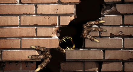 Paws of monster , breaking a brick wall © frenta