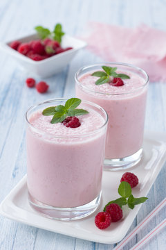 Milkshake with fresh raspberries in a glass