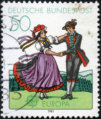 South German couple dancing in regional costumes
