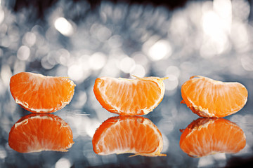 mandarin oranges and cloves on blurred background freshness