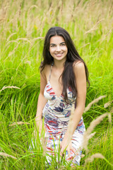 Beautiful young woman in colorful dress