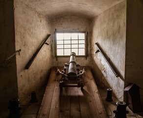 Old cannon in castle interior