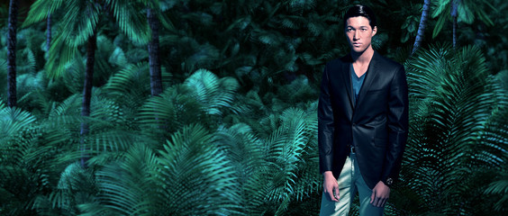 Asian business fashion man in jungle with green ferns and palm t