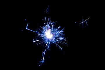 Christmas sparkler on black background. Bengal fire