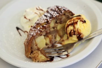 Apple strudel with whipped cream and vanilla ice cream