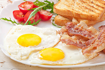 English breakfast - toast, egg, bacon and vegetables