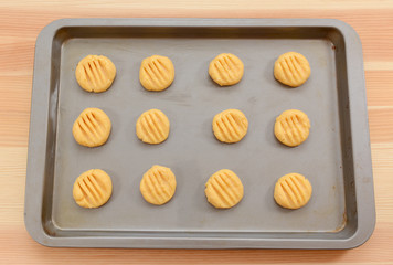 Balls of biscuit dough marked with a fork