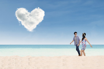 Romantic couple walking on the beach