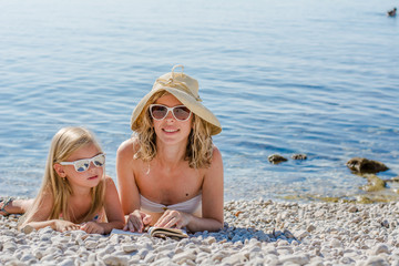 mother and daughter reading book