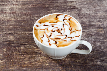 Cup of coffee on old wooden table