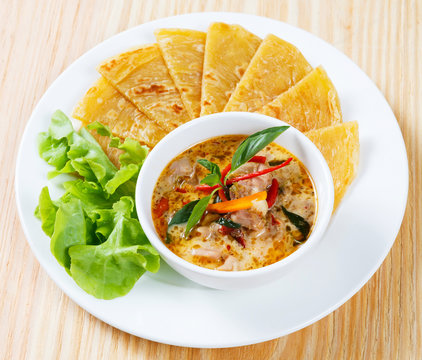 Indian pancake with chicken curry