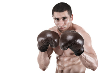 Fototapeta na wymiar Young muscular man, boxer posing in studio in gloves, isolated