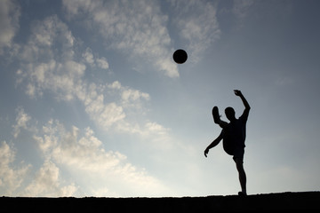 Fototapeta na wymiar Silhouette of soccer man playing with the ball